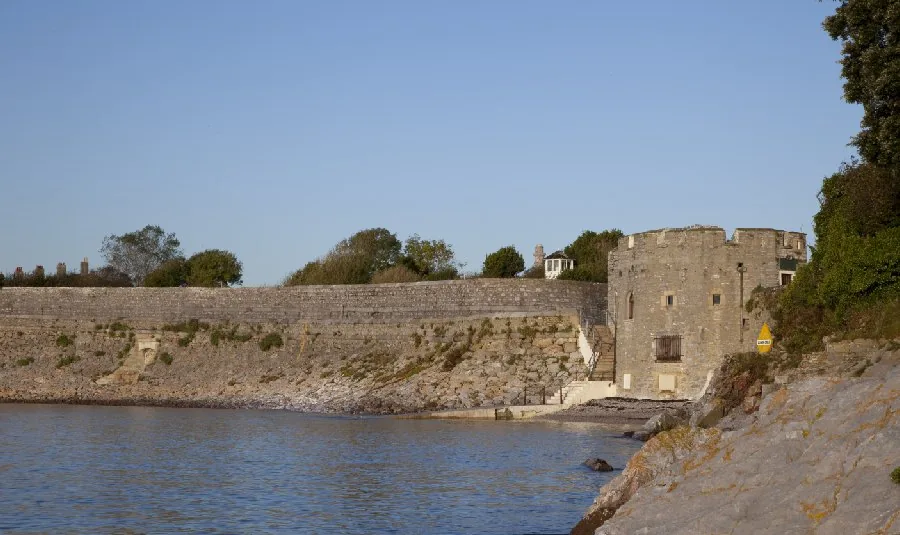 The tower and the curving sea wall photographed from the water